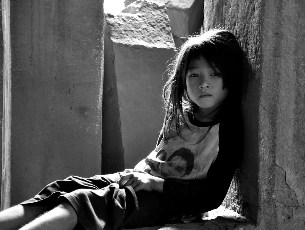 little girl sitting alone outside