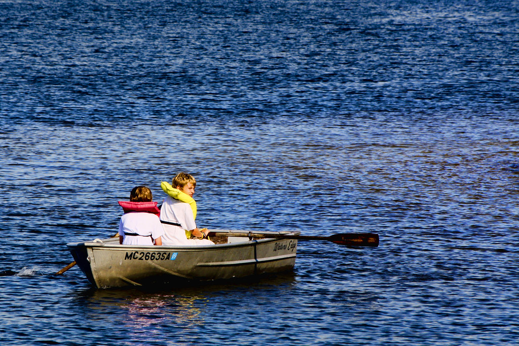 kids in rowboat on the lake.